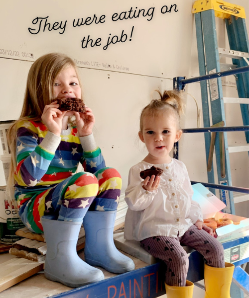 Girls eating donuts on scaffolding